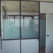 División de oficina simple, compuesta por madera y cristal.